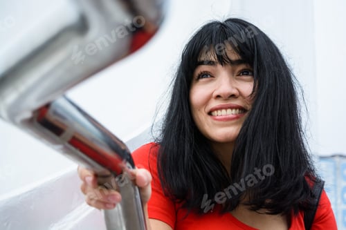 Preview: closeup of beautiful latin young woman watching attentively, smiling and curious face