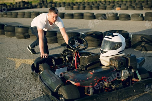 Preview: Handsome man in a karting with a car