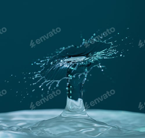 Preview: Beautiful shot of water splash isolated on a blue background- perfect for backgrounds