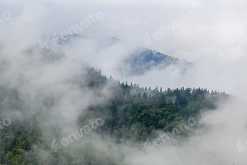 Preview: Majestic view on beautiful fog and cloud mountains in mist landscape