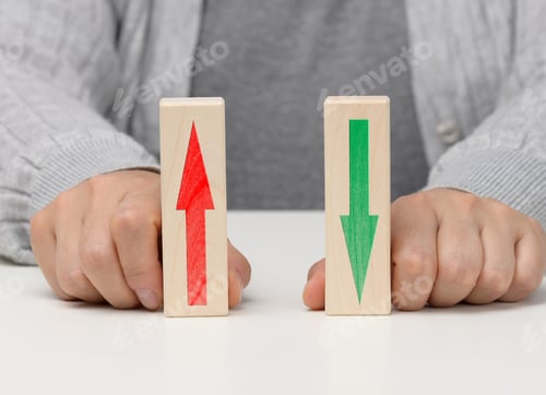 Preview: Female hand holds wooden blocks with up and down arrows.