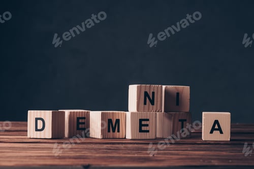 Preview: wooden cubes with dementia letters on table on black background