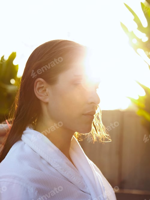 Preview: Caucasian woman in robe standing outdoors