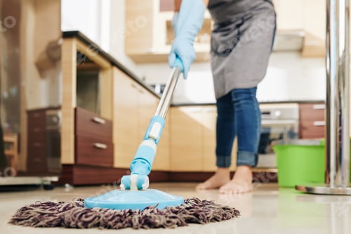 Preview: Housewife mopping kitchen