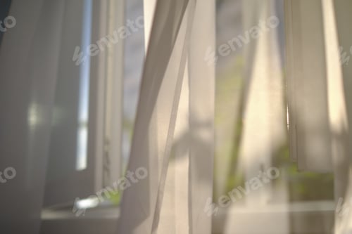 Preview: defocus warm sunlight through the transparent tulle illuminates the room. Sunny day, the sun's rays