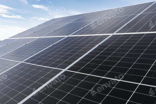 Preview: Solar panels absorbing sunlight under a cloudy blue sky
