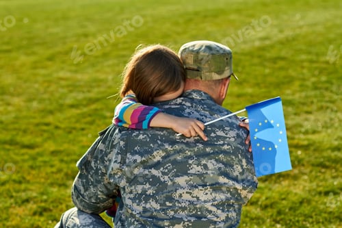 Preview: European soldier is hugging his little daughter.