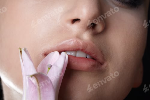 Preview: Close-Up Portrait Of Half Face Of Beautiful Model Nipping Flower'S Petal