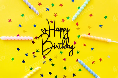 Preview: The inscription happy birthday on a yellow background. Festive background with candles, confetti in
