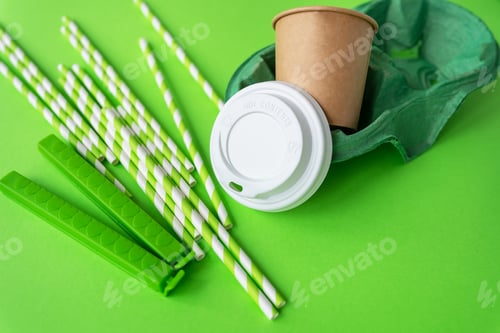 Preview: A green background on which a glass, tubes, a bag clip, a stand, a lid. Plastic and recycling