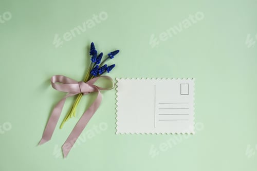 Preview: Bouquet of tender hyacinths tied with satin pink ribbon, and greeting card on pale green background