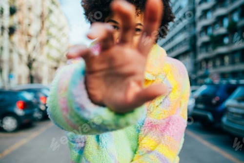 Preview: Young mixed race curly hair woman dancing outdoor gesturing