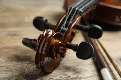 Preview: Beautiful violin and bow on wooden table, closeup