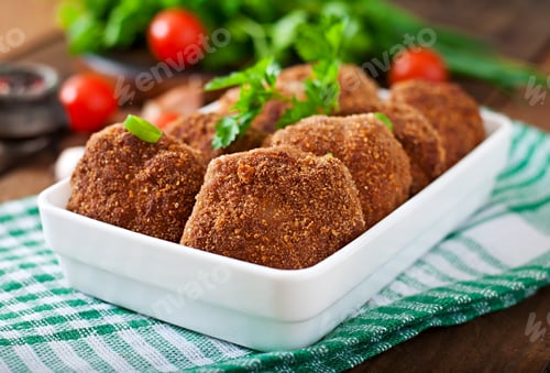 Preview: Juicy delicious meat cutlets on a wooden table in a rustic style.