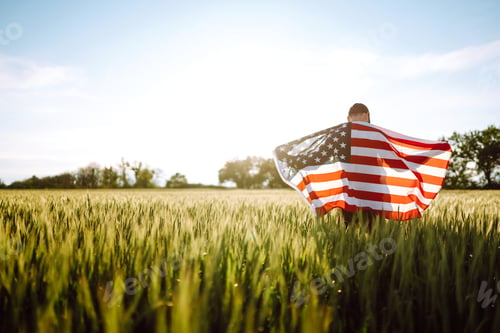 Preview: Man hold waving american USA flag. Patriot raise national american flag. Independence Day, 4th July.