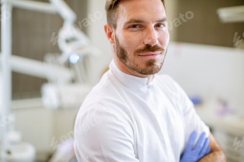 Preview: Handsome dentist posing in modern dental office