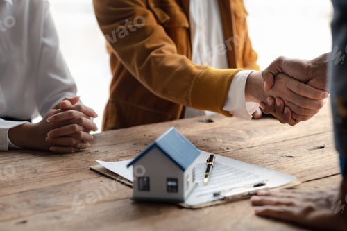 Preview: Real estate sales agents shake hands with customers of housing projects, explaining and presenting i