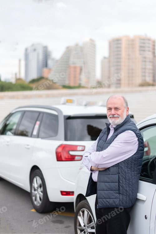 Preview: the elderly taxi driver in front of his white cab waiting for the customer- transport concept
