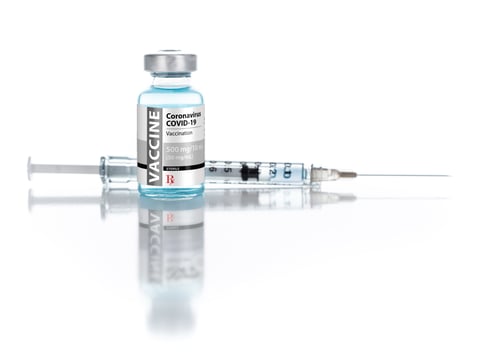 Preview: Coronavirus COVID-19 Vaccine Vial and Syringe On Reflective White Background