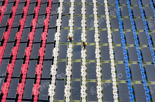 Preview: Wide shot of aeroview or top view of two technician workers walk along the solar panel system