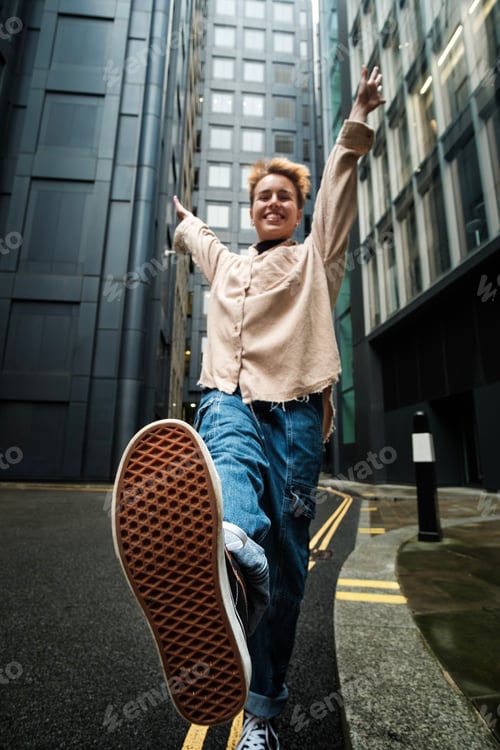 Preview: Exaggerated view of young woman showing euphoria in the street.