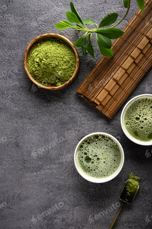 Preview: Matcha tea powder and tea accessories on dark background.