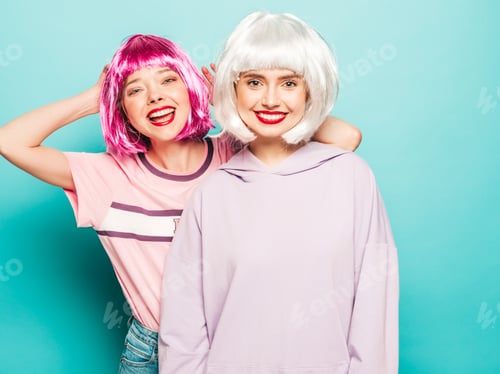 Preview: Portrait of two young funny women posing in studio