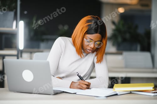 Preview: Focused serious african american female student studying in classroom