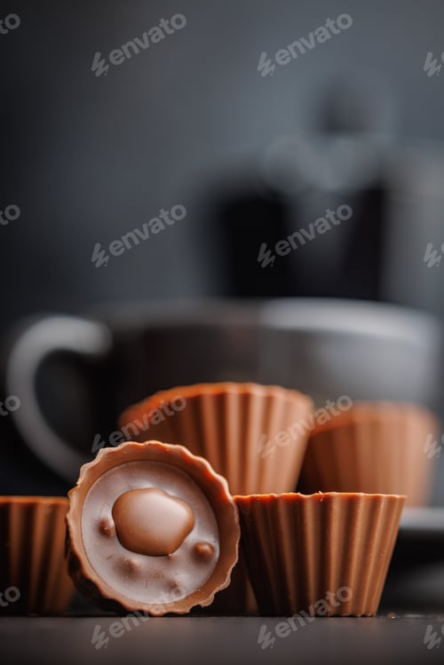 Preview: Sweet pralines. Chocolate truffles on black table.