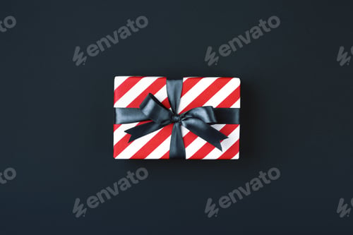 Preview: Gift Box Tied with Black Bow on Black Background.