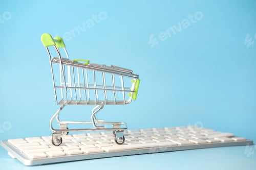 Preview: Empty shopping trolly cart on keyboard.