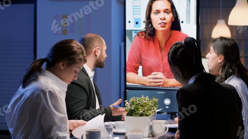 Preview: Diverse multi-ethnic businesspeople discussing with remote manager during online videocall