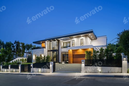 Preview: Modern luxury house exterior illuminated at dusk.