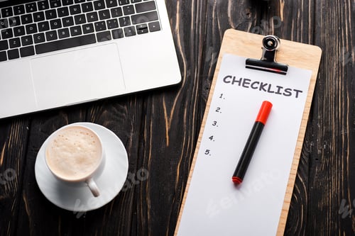 Preview: top view of laptop near checklist, red marker pen and cup of coffee on table, e-commerce concept