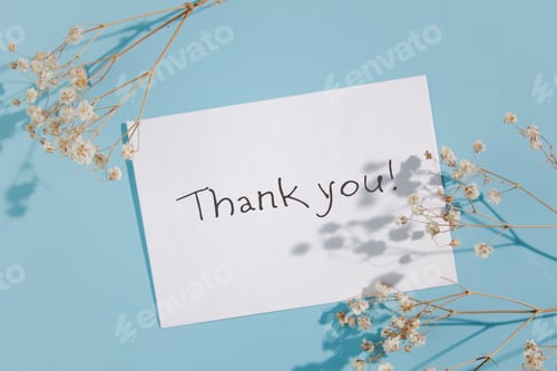 Preview: Thank you in cursive blue font on sky blue card with twig flower design