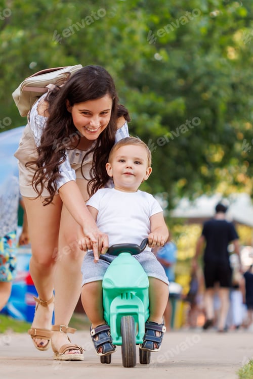 Preview: Mother helping son learn to ride a bike