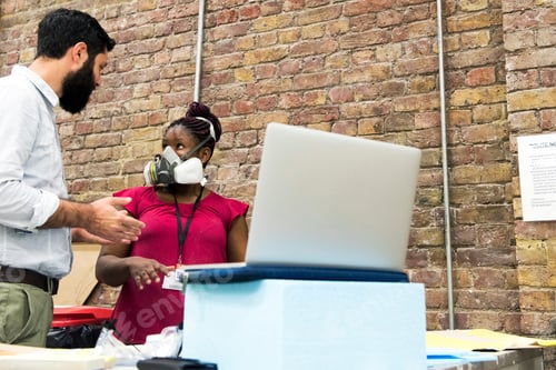 Preview: Tutor in art college chatting to student wearing protective mask