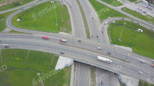 Preview: Aerial view of a freeway intersection. Clip. Highway and overpass with cars and trucks, interchange