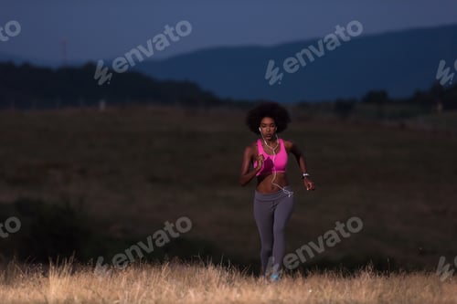 Preview: Young African american woman jogging in nature