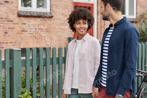 Preview: People, leisure, relationship and ethnicity concept. Glad interracial girlfriend and boyfriend hold