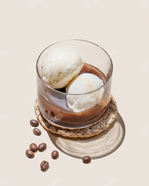 Preview: Affogato coffee with vanilla ice cream scoops and espresso in a glass on a light background