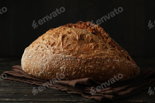 Preview: Towel with fresh baked bread on wooden table