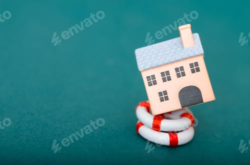 Preview: Property Safety and Security House Resting on Life Preserver on Teal Background