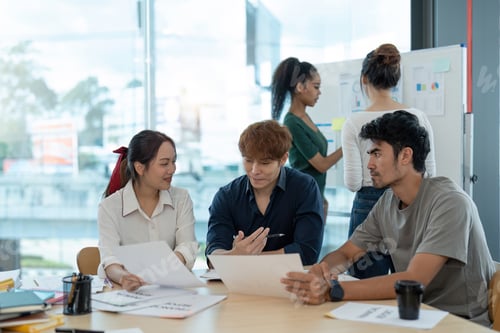 Preview: Diverse colleagues working on project together. Diverse Team of Creative Professionals Talk