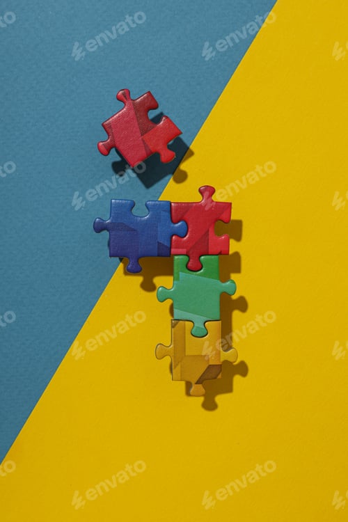 Preview: Multicolored puzzle pieces on a blue-yellow background