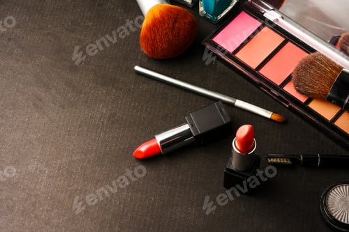 Preview: Top view of cosmetics set for makeup on a black background. Free space for text.