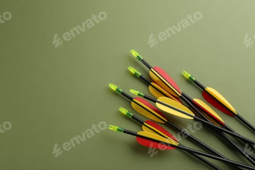 Preview: Plastic arrows on olive background, flat lay with space for text. Archery sports equipment