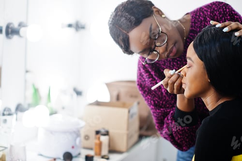 Preview: African American woman applying make-up