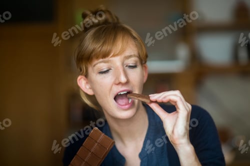 Preview: Young woman eating chocolate