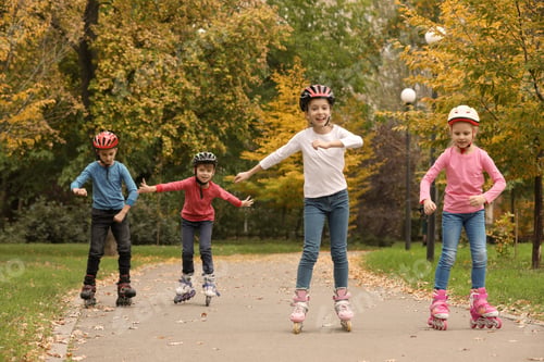 Preview: Happy children roller skating in autumn park